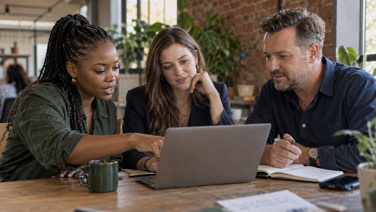 Two fintech co-founders and an accountant reviewing a financial model together